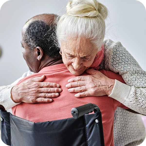 Senior woman hugging man